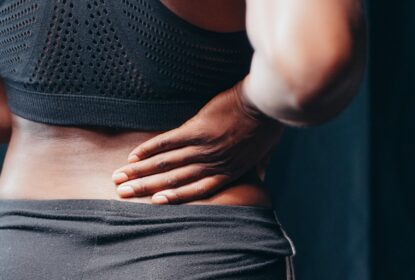 woman holding lower back pain